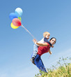 Photo: Mother and son playing with balloons in nature Mother and son playing with balloons in nature