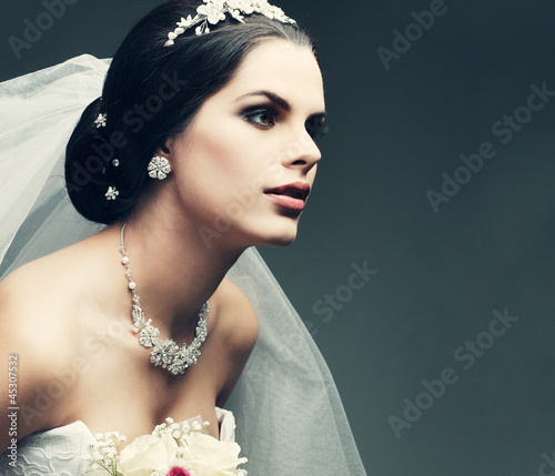 Photo: Portrait of beautiful bride. Wedding dress. Wedding decoration Portrait of beautiful bride. Wedding dress. Wedding decoration