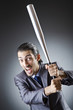 Angry businessman with bat on white