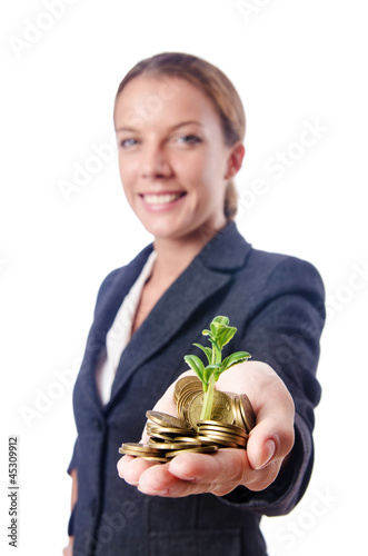 Photo: Businesswoman with seedlings and coins Businesswoman with seedlings and coins