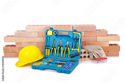 Photo: Construction concept with helmet and toolkit Construction concept with helmet and toolkit