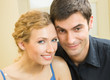 Cheerful smiling young couple, indoors