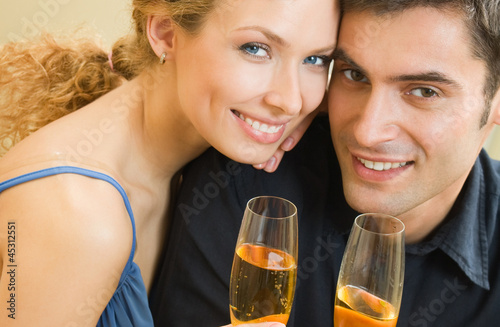 Photo: Cheerful couple with champagne Cheerful couple with champagne