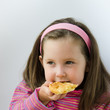 Photo: Pretty little girl eats a pancake for breakfast Pretty little girl eats a pancake for breakfast