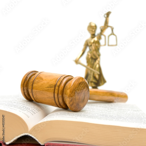 Photo: gavel, law book, a statue of justice on a white background gavel, law book, a statue of justice on a white background