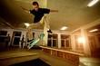 Young man performing a stunt in a skatepark