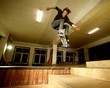 Young man performing a stunt in a skatepark