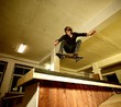 Young man performing a stunt in a skatepark