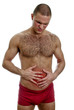 Front view of muscular man suffering from stomach pain.