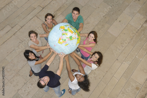 Photo: Multiracial group holding the Earth Globe showing Africa Multiracial group holding the Earth Globe showing Africa