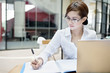 Businesswoman writes on a document