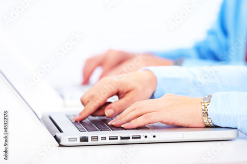 Photo: Hands with a computer keyboard. Hands with a computer keyboard.
