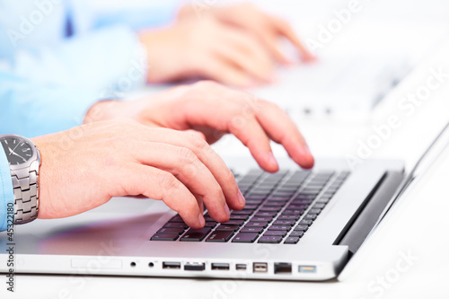 Photo: Hands with a computer keyboard. Hands with a computer keyboard.