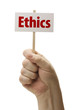 Hand Held Ethics Sign In Fist On White