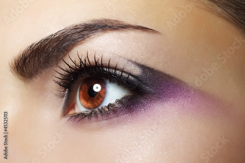 Photo: Purple Eye Makeup. Beautiful eye makeup close up Purple Eye Makeup. Beautiful eye makeup close up