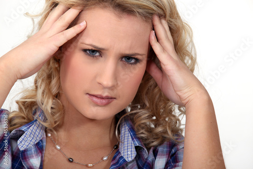Photo: Woman suffering from a throbbing headache Woman suffering from a throbbing headache
