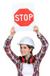 Female builder holding stop sign