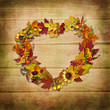 Wreath of autumn leaves on a wooden background