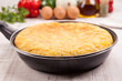 Fresh homemade Spanish tortilla (omelette) in the frying pan