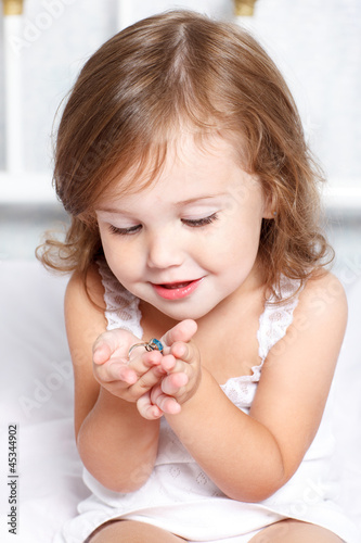 Photo: Girl holding golden ring Girl holding golden ring