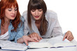 Young women looking up a word in the dictionary