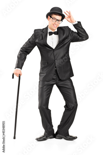 Photo: Full length portrait of a man holding a cane and gesturing Full length portrait of a man holding a cane and gesturing