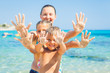 Family playing on sandy beach