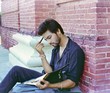 Indian college student studying in the college campus.