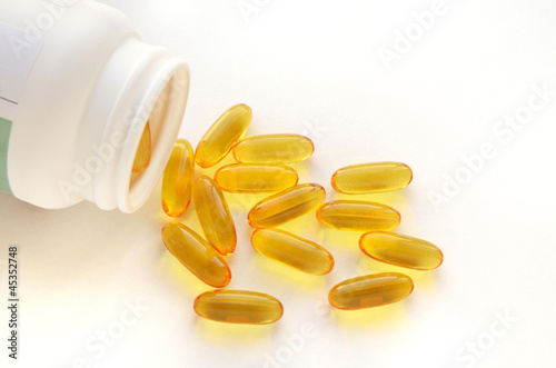 Photo: Fish oil capsules and container Fish oil capsules and container