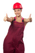 Happy female construction worker showing thumbs up