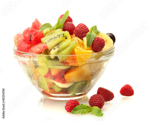 Photo: fresh fruits salad in bowl and berries, isolated on white fresh fruits salad in bowl and berries, isolated on white