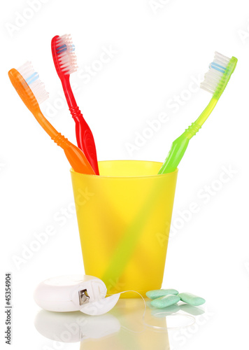Photo: Toothbrushes, chewing gum and dental floss isolated on white Toothbrushes, chewing gum and dental floss isolated on white