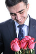 A man in a suit with a rose. Smiling. Isolated on white.