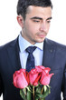 Solid man in a suit with roses. Isolated on white