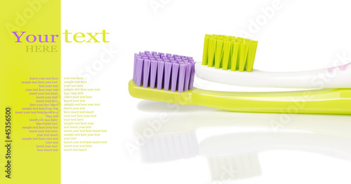 Photo: Two colored toothbrushes Two colored toothbrushes