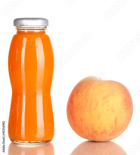 Photo: Delicious peach juice in glass bottle and peach next to it Delicious peach juice in glass bottle and peach next to it