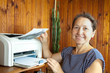 Foto: woman near the printer pulls paper woman near the printer pulls paper