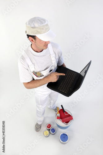 Photo: Decorator with a laptop Decorator with a laptop