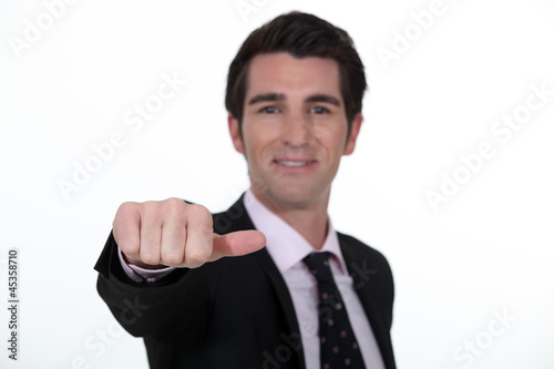 Photo: Businessman sticking out his thumb Businessman sticking out his thumb