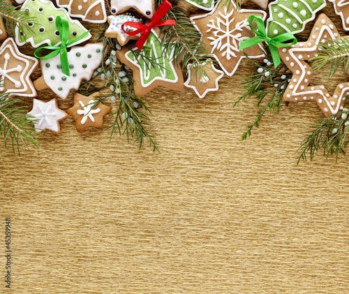 Photo: Christmas Ginger cookies on gold background. Christmas Ginger cookies on gold background.