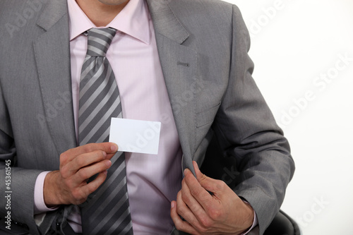 Photo: businessman showing business card businessman showing business card