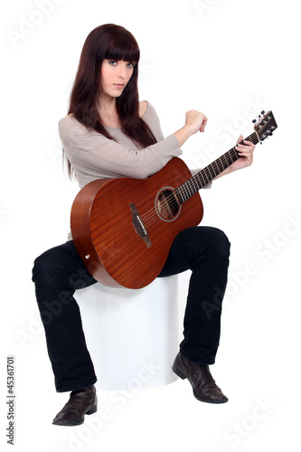 Photo: young woman playing guitar young woman playing guitar
