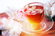 Herbal tea in a glass bowl with flowers of apple