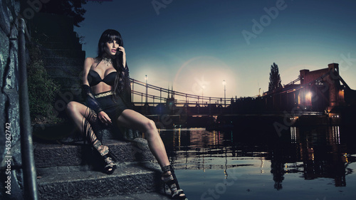 Photo: Sexy brunette sitting by the river Sexy brunette sitting by the river