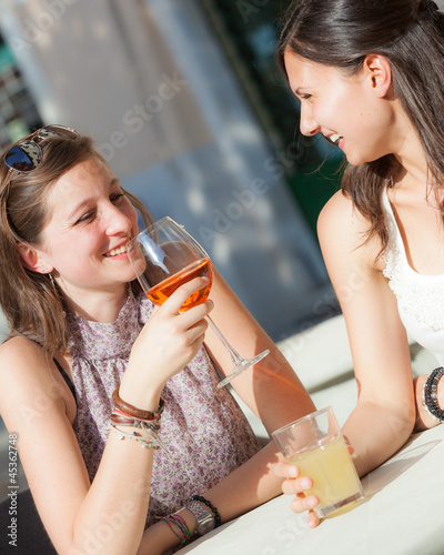 Photo: Two Young Women with a Cold Drink Two Young Women with a Cold Drink