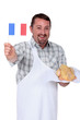 Man holding French flag and fresh chicken
