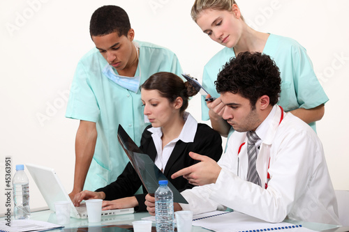 Photo: hospital staff analyzing a case hospital staff analyzing a case