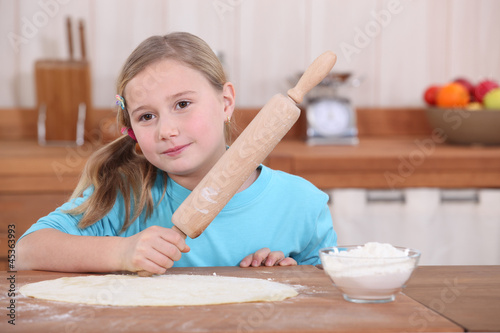 Photo: Little girl with rolling pin Little girl with rolling pin