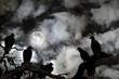 Vultures silhouetted against a full moon and spooky sky