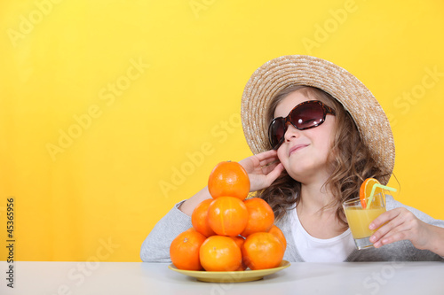Photo: Little girl with freshly squeezed orange juice Little girl with freshly squeezed orange juice